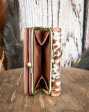 Inside of the coin pouch in the Mesa Terra Vintage Style Wallet, displayed on a wood, wood backdrop.