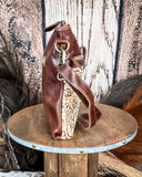 Side view of the Fennington Leather Bag in Ivory displayed on a wood table, wood back drop.