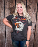 Girl modeling the Badlands Motorcycle Club Graphic Tee with a wood back drop.