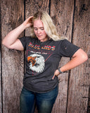 Girl modeling the Badlands Motorcycle Club Graphic Tee with a wood back drop.