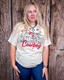 A girl modeling the Kick Rocks Cowboy Distressed Graphic Tee with a wood backdrop.