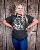 Model wearing the Cowboys Never Die Distressed Graphic Tee with a white back drop.