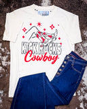 The Kick Rocks Cowboy Distressed Graphic Tee displayed on cowhide along with jeans.