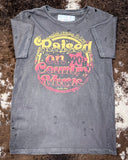 The Raised on 90's Country Distressed Graphic Tee displayed on cowhide.