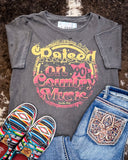 The Raised on 90's Country Distressed Graphic Tee displayed on cowhide along with shoes and jeans.