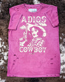 The Adios Cowboy Distressed Graphic Tee displayed on cowhide.