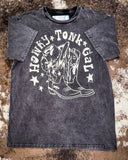 Honky Tonk Gal Vintage Graphic Tee displayed on cowhide.