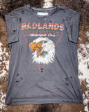 Badlands Motorcycle Club Graphic Tee displayed on cowhide,