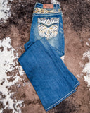 The Emberglow Embellished Bootcut Jeans displayed on cowhide.
