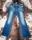 Front view of the Emberglow Embellished Bootcut Jeans displayed on cowhide.