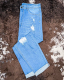 The Coyote Trail High-Rise Mom Jeans displayed on cowhide.