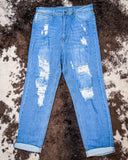 Front view of the Coyote Trail High-Rise Mom Jeans displayed on cowhide.