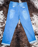 Back view of the Coyote Trail High-Rise Mom Jeans displayed on cowhide.