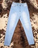 Front view of the High Noon Skinny Jeans displayed on cowhide.