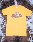 The Don't Mess with the Cowgirl Graphic Tee displayed on cowhide.