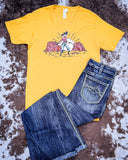 The Don't Mess with the Cowgirl Graphic Tee displayed on cowhide along with jeans.