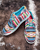 The Paloma Pop Twisted X Hooey Loper displayed on cowhide.