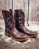Side view of the Taffy Twisted X Women's 11" Tech X Boot on cowhide with a wood back drop.