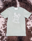The Legacy Rider Graphic Tee displayed on cowhide.