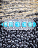 The Rayna Genuine Turquoise Bracelet displayed on beans and wheat.