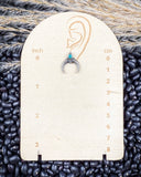 The Naja Genuine Turquoise Earrings displayed on a ruler showing it's size on beans and wheat.