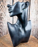 The Vale Genuine Turquoise Stud Earrings on a mannequin, sitting on a wood table, wood backdrop.