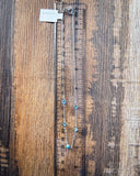 The 5 Stone Genuine Turquoise Choker Necklace displayed on a ruler showing size with a wood backdrop