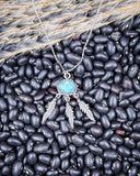 The Abey Genuine Turquoise Necklace displayed on beans and wheat.