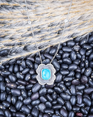The Asia Genuine Turquoise Necklace displayed on beans and wheat.