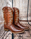 Side view of the Rustwood Rodeo Circle G Boots in  front of a wood backdrop.