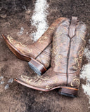 Dustwing Canyon Circle G Boots laying on cowhide.