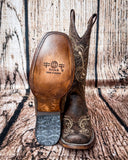 Sole view of the Dustwing Canyon Circle G Boots in front of a wood backdrop.