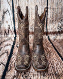 Front view of the Dustwing Canyon Circle G Boots in front of a wood backdrop.