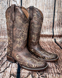 Side view of the Dustwing Canyon Circle G Boots in front of a wood backdrop.