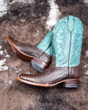 Serpent Spur Circle G Boots laying on cowhide.