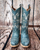 Front view of the Blue Ridge Wrangler Circle G Boots displayed on cowhide.