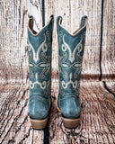 Back view of the Blue Ridge Wrangler Circle G Boots in a wood backdrop.