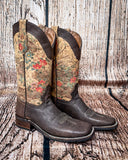 Side view of the Bronco Belle Circle G Boots in a wood backdrop.
