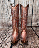 Front view of the Champagne Rodeo Snip Toe Corral Boots in front of a wood backdrop.