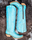 The Embroidered Sky Corral Boots displayed on cowhide.
