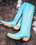 The Embroidered Sky Corral Boots displayed on cowhide.