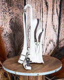 Right side view of the Ridge Bloom Tooled Sling Bag - Ivory on a wood backdrop.