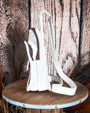 Left side view of the Ridge Bloom Tooled Sling Bag - Ivory on a wood backdrop.