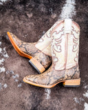 The Sundance Python Corral Boots displayed on cowhide.