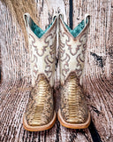 Front view of the Sundance Python Corral Boots in a wood backdrop.