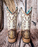 Back view of the Sundance Python Corral Boots in a wood backdrop.