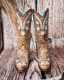 Front view of the Rodeo Afterglow Corral Boots in a wood backdrop.
