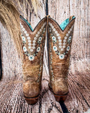 Back view of the Rodeo Afterglow Corral Boots in a wood backdrop.