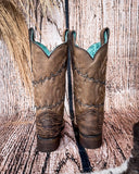Back view of the Barbed Trailblazer Corral Boots in a wood backdrop.