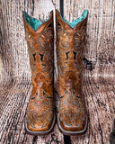 Front view of the Saddleback Shadow Corral Boots in a wood backdrop.